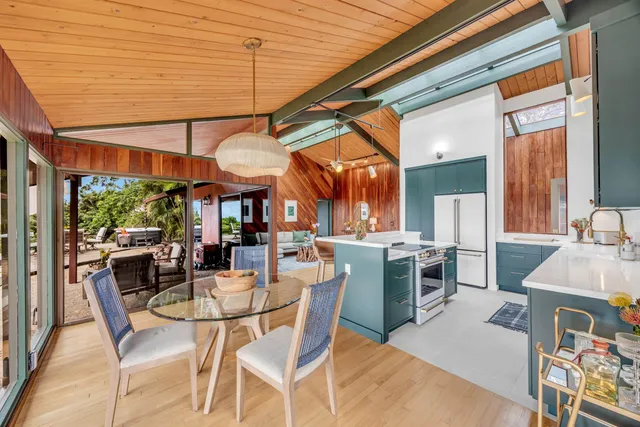 a dining room with furniture and a large window