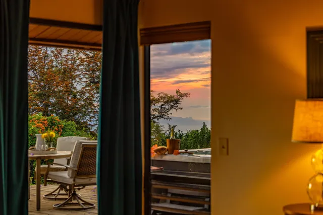 a view of a room with a large window and furniture