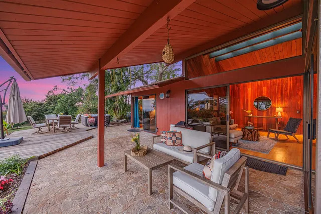 a view of a patio with a table and chairs under an umbrella