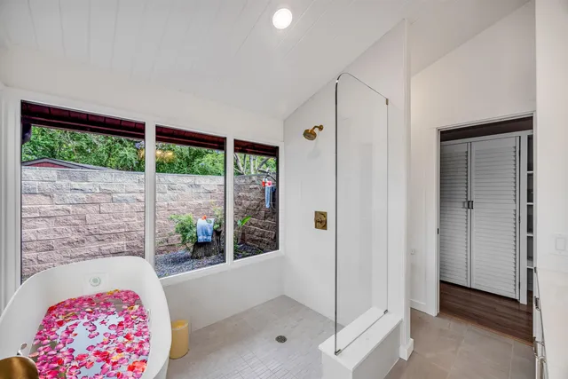 a bathroom with a tub and shower