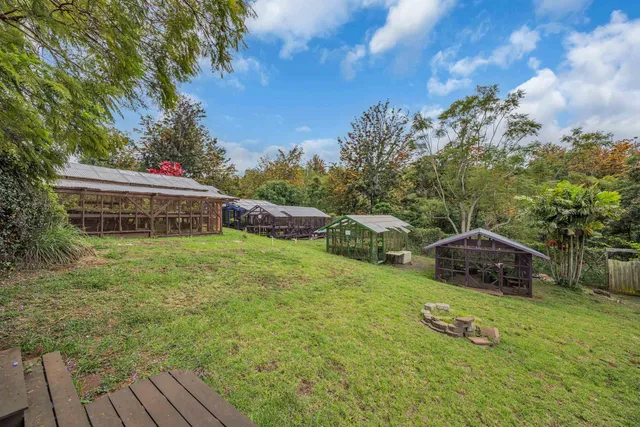 a backyard of a house with table and chairs