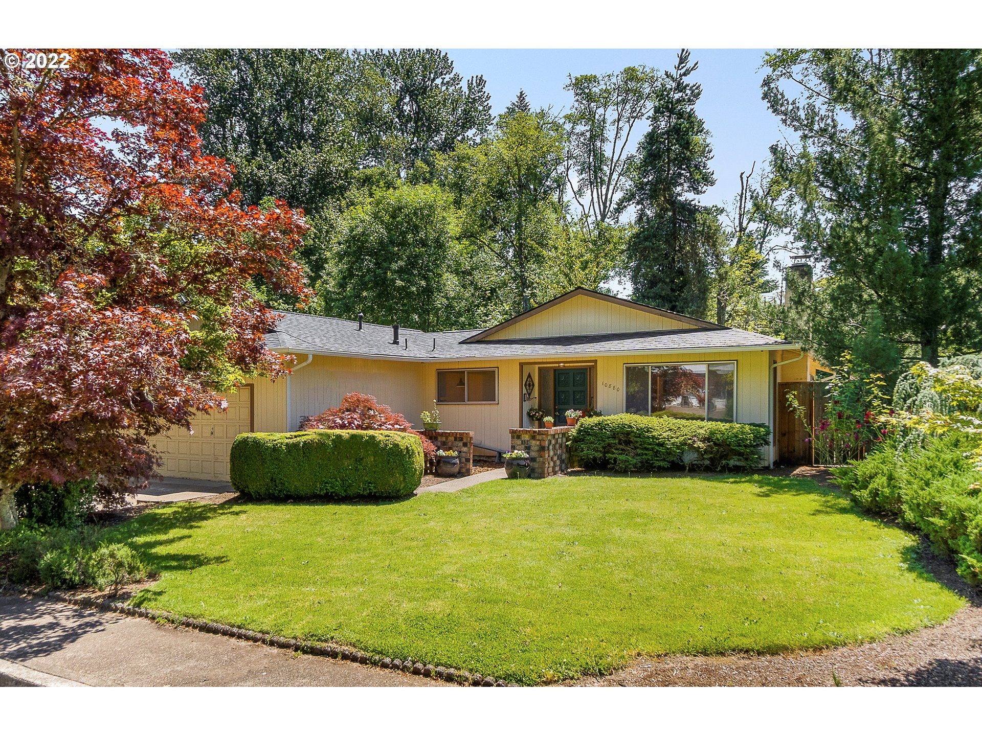 a front view of a house with garden