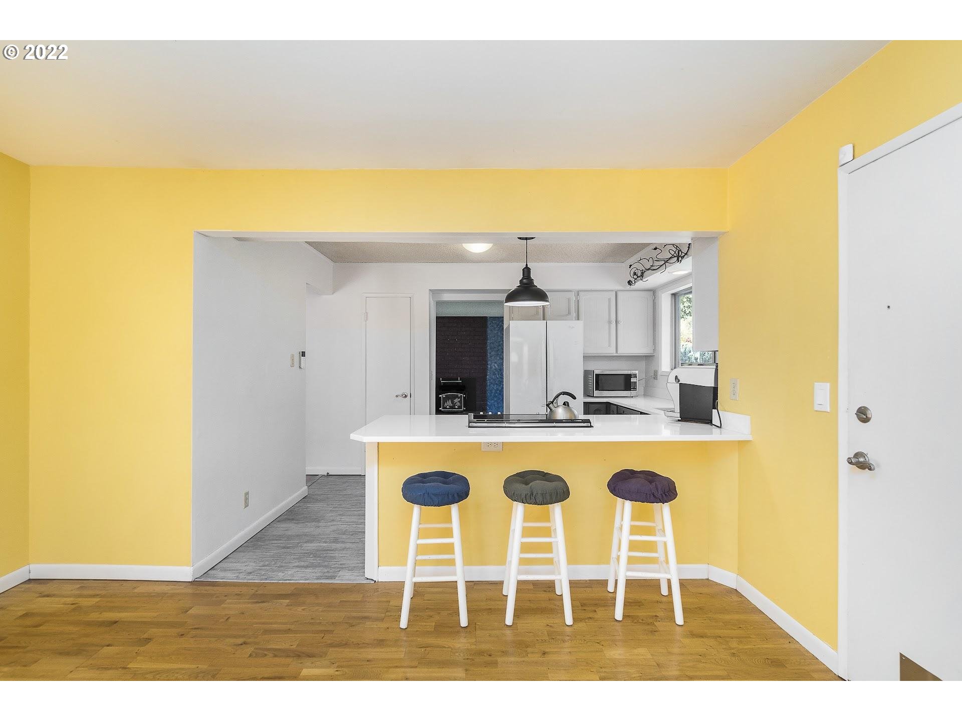 10880 Southwest Pathfinder Way Tigard, OR 97223 - Photo 13 of 26 a view of a dining room with wooden floor