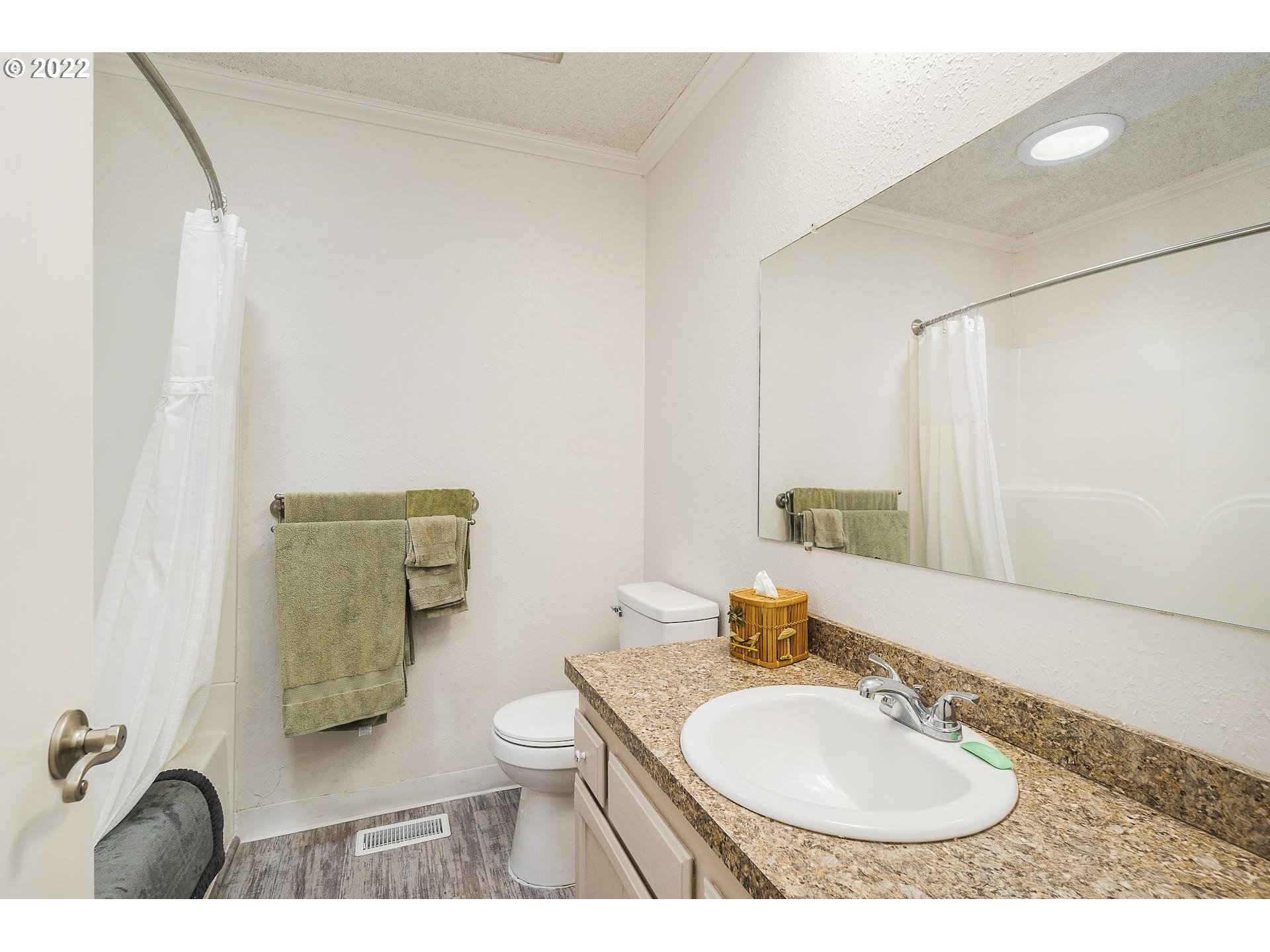 10880 Southwest Pathfinder Way Tigard, OR 97223 - Photo 17 of 26 a bathroom with a toilet a sink and mirror