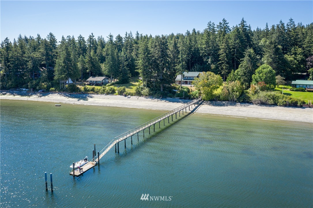 525 Port Stanley Road Lopez Island, WA 98261 - Photo 1 of 28 a view of a lake with a yard and large trees