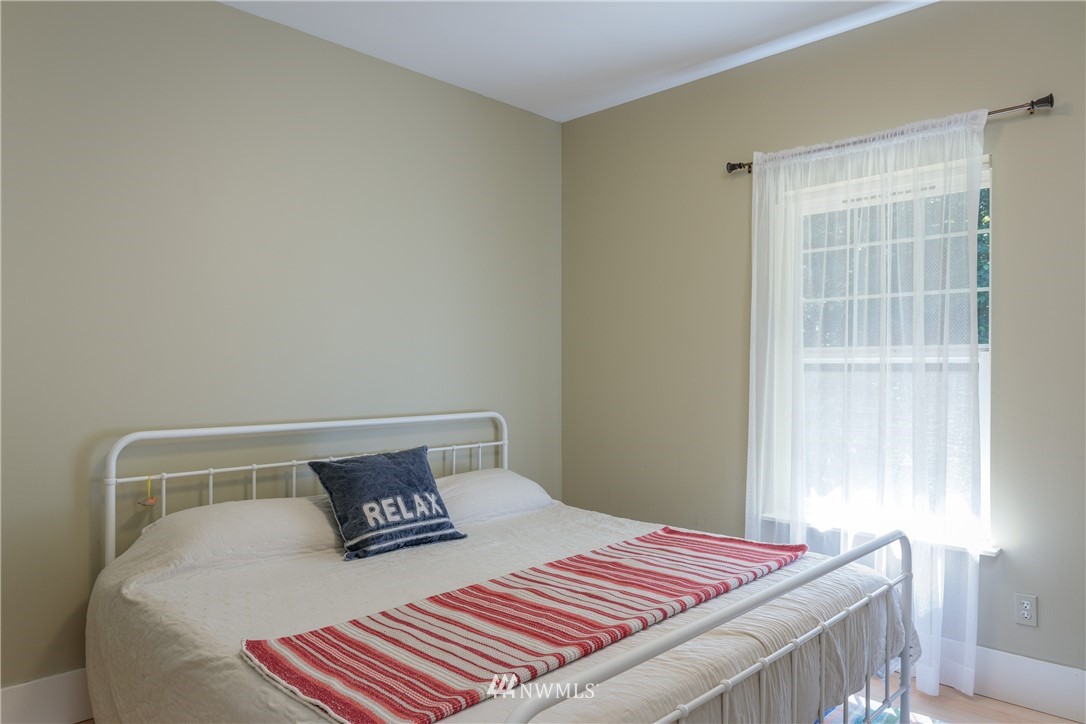 525 Port Stanley Road Lopez Island, WA 98261 - Photo 14 of 28 a bedroom with a bed and a window