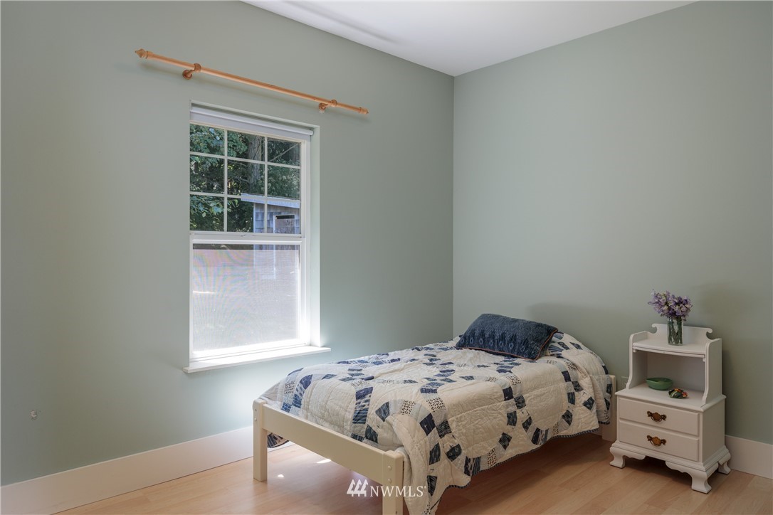 525 Port Stanley Road Lopez Island, WA 98261 - Photo 15 of 28 a bedroom with a bed and a window