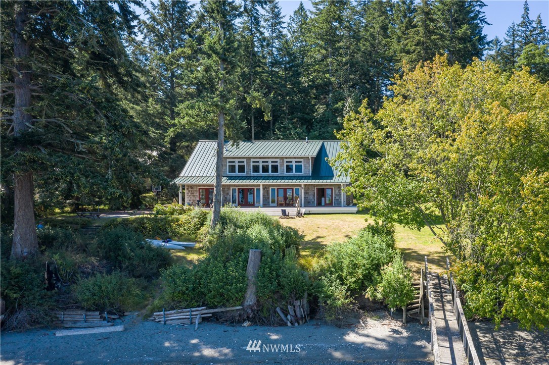 525 Port Stanley Road Lopez Island, WA 98261 - Photo 3 of 28 a view of a house with a small yard plants and large trees