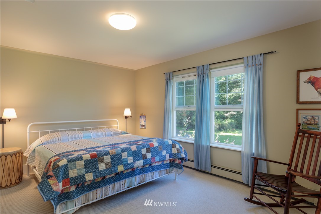 525 Port Stanley Road Lopez Island, WA 98261 - Photo 21 of 28 a bedroom with a bed chair and a window