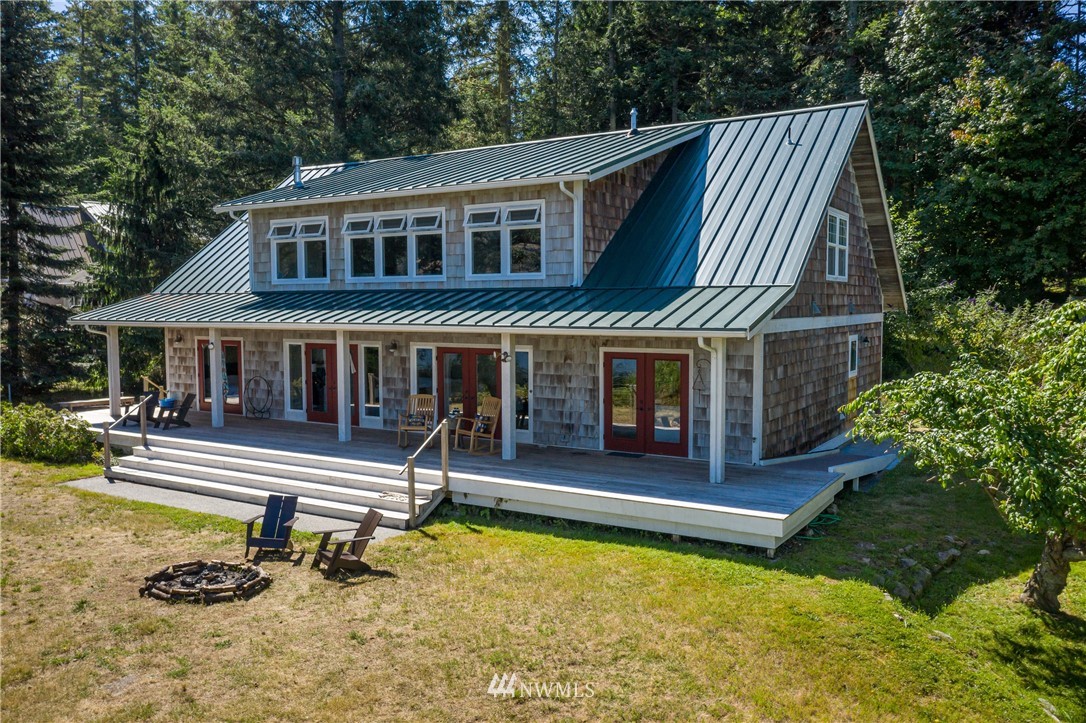 525 Port Stanley Road Lopez Island, WA 98261 - Photo 24 of 28 a view of a house with pool and chairs