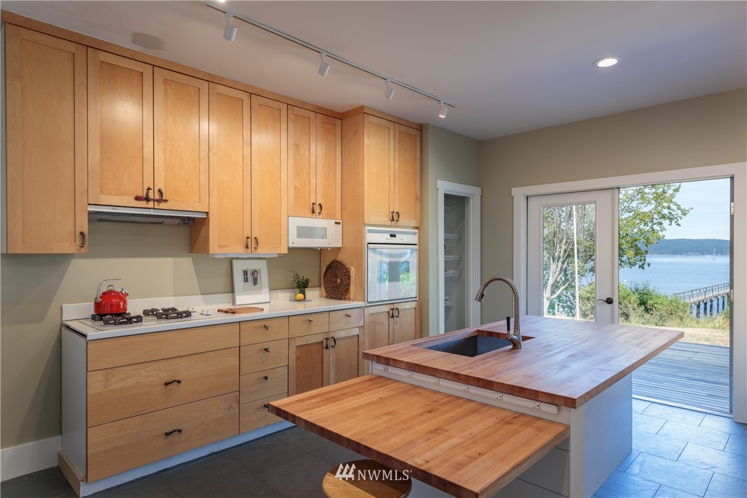 525 Port Stanley Road Lopez Island, WA 98261 - Photo 8 of 28 a kitchen with kitchen island a sink stove and window