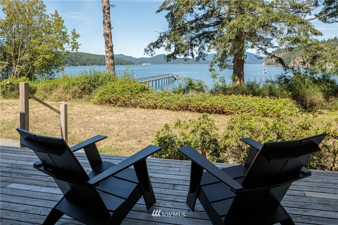 525 Port Stanley Road Lopez Island, WA 98261 - Photo 9 of 28 a view of a balcony with chairs and wooden floor