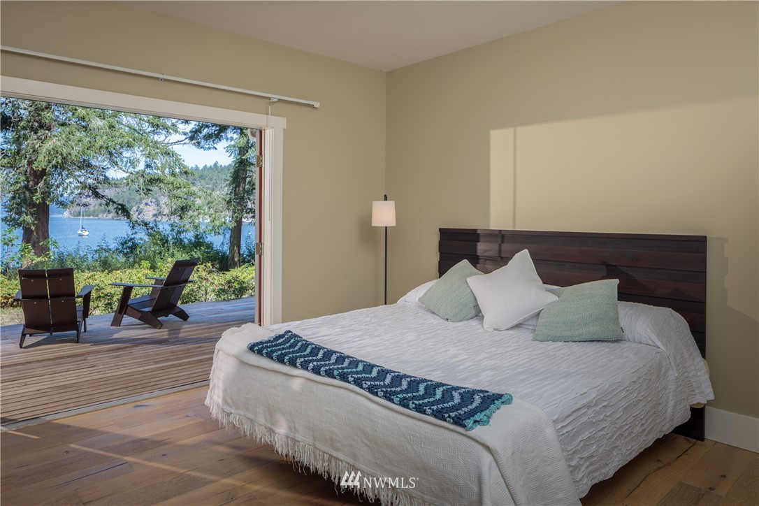 525 Port Stanley Road Lopez Island, WA 98261 - Photo 10 of 28 a large bed sitting in a bedroom next to a window with yard