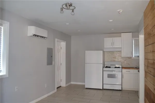 a kitchen with white cabinets and white appliances