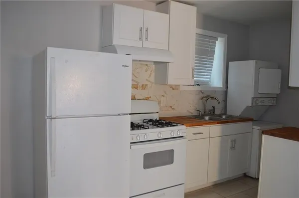 a white refrigerator freezer sitting inside of a kitchen