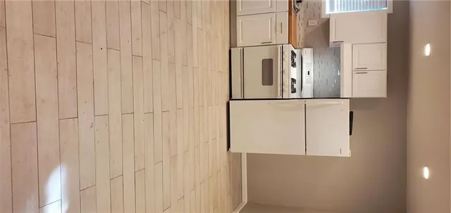 a view of a kitchen with wooden floor and staircase