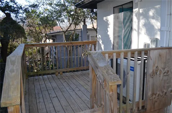 a view of balcony with wooden floor and fence