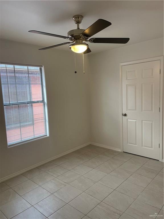 1408 Pine Street, Unit D Weslaco, TX 78596 - Photo 7 of 10 Spare room featuring light tile patterned floors and a ceiling fan