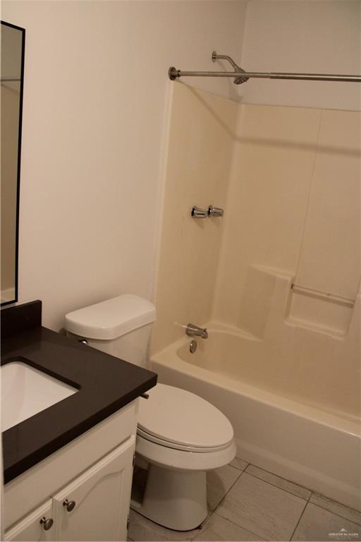 1408 Pine Street, Unit D Weslaco, TX 78596 - Photo 8 of 10 Full bathroom with shower combination, light tile patterned floors, and vanity