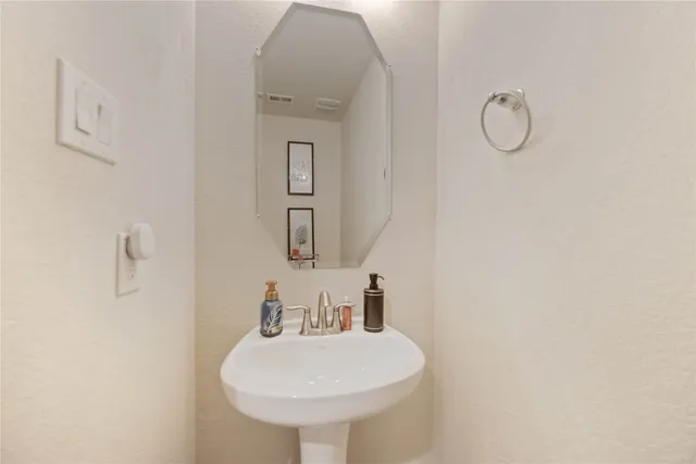 a bathroom with a sink toilet and mirror