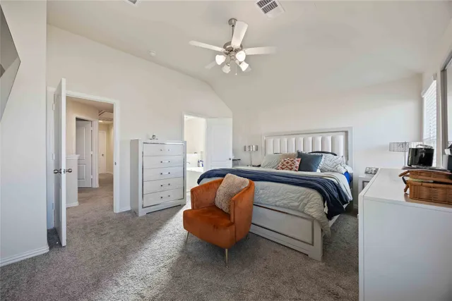 a bedroom with a bed and ceiling fan