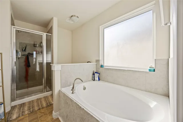 a bathroom with a bathtub and a shower