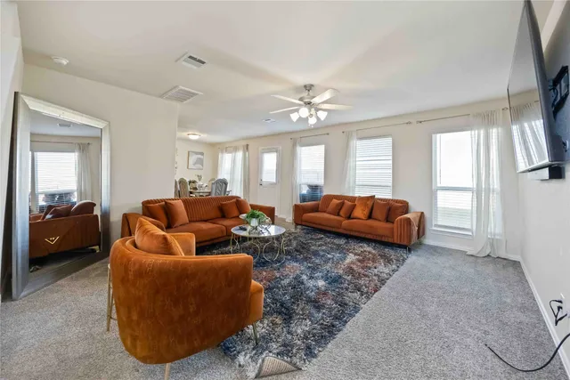 a living room with furniture and a large window