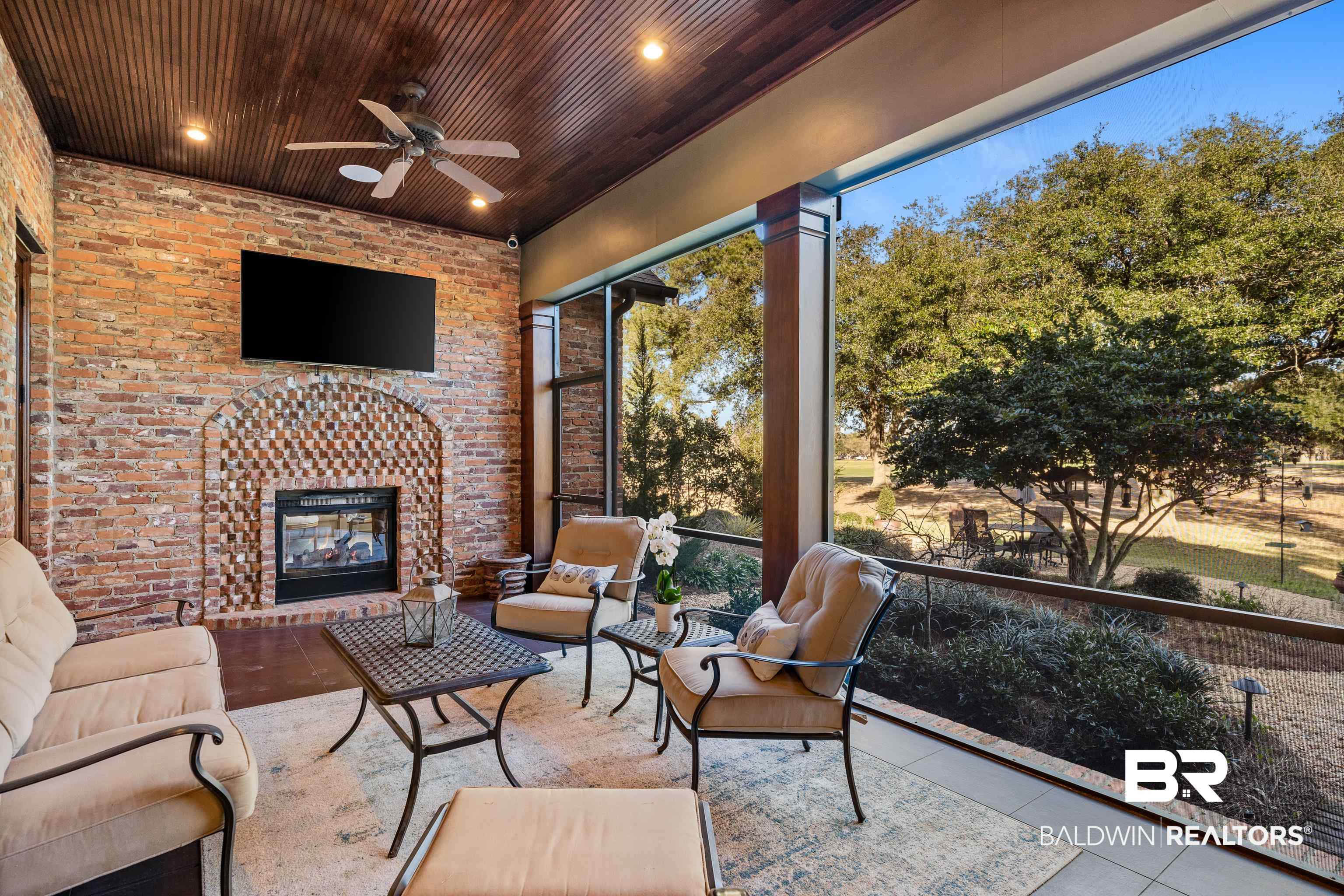 3613 Old Park Road Gulf Shores, AL 36542 - Photo 58 of 72 Sunroom with a healthy amount of sunlight, wooden ceiling, an outdoor brick fireplace, and a ceiling fan