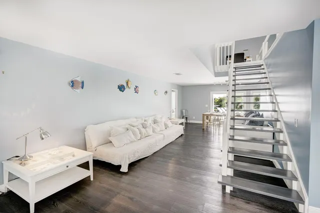 a living room with furniture and large windows