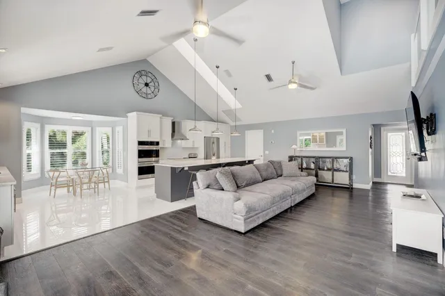 a large white kitchen with a large window