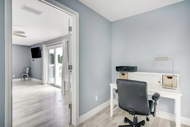 a white bath tub sitting next to a shower