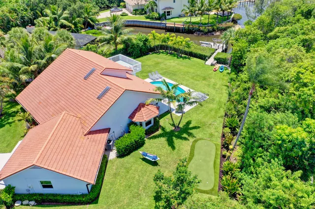 an aerial view of a house with garden space and street view
