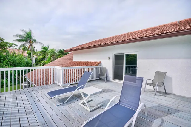 a view of a house with swimming pool and sitting area