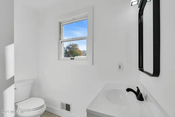 a white toilet sitting next to a bathroom sink