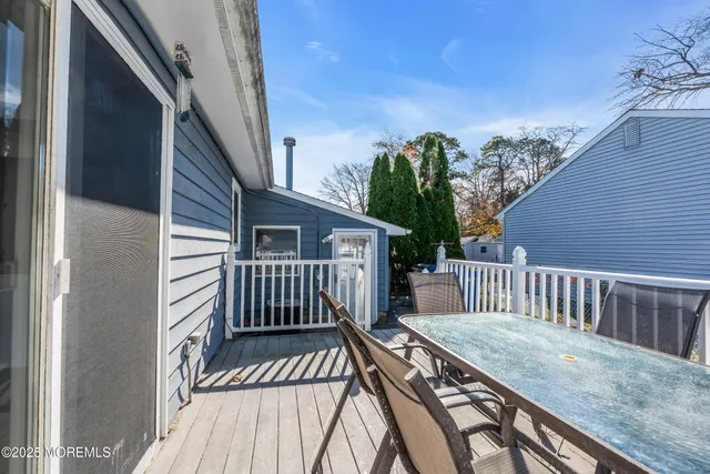 a view of a wooden deck and a backyard