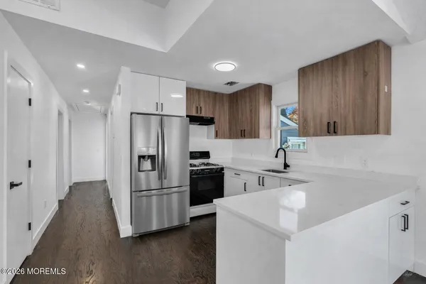 a kitchen with wooden cabinets and stainless steel appliances