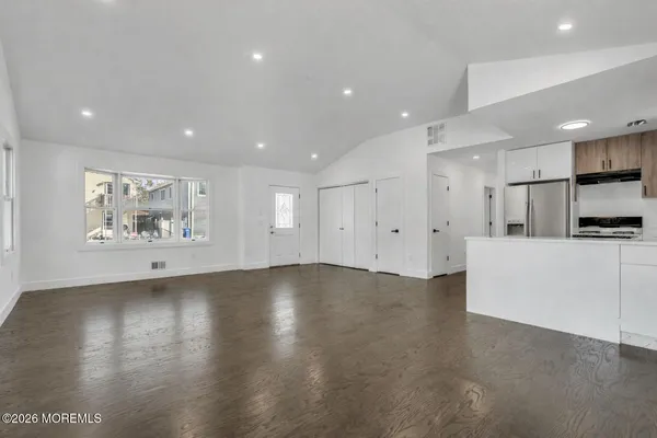 a view of an empty room with a kitchen