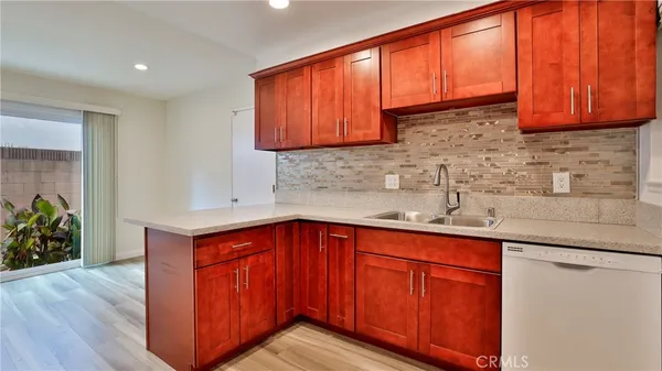 a stove top oven sitting inside of a kitchen