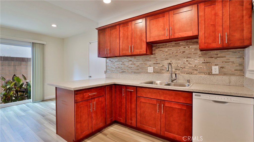 304 Navajo Springs Road Diamond Bar, CA 91765 - Photo 13 of 39 a kitchen with stainless steel appliances granite countertop wooden cabinets a sink and dishwasher with wooden floor
