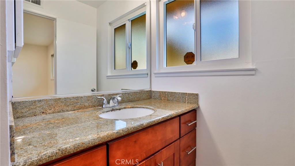 304 Navajo Springs Road Diamond Bar, CA 91765 - Photo 19 of 39 a bathroom with a granite countertop sink and a mirror