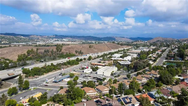 a view of a city with lush green forest