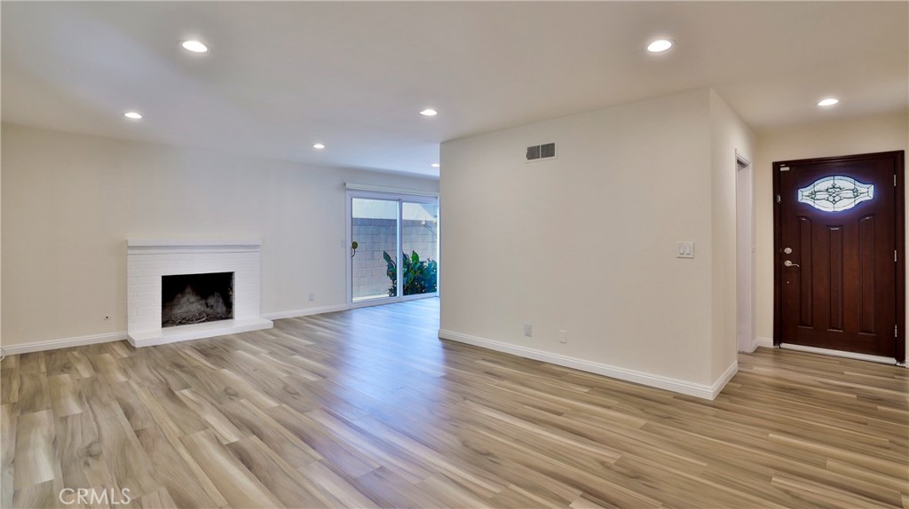 304 Navajo Springs Road Diamond Bar, CA 91765 - Photo 5 of 39 a view of an empty room with wooden floor and a fireplace