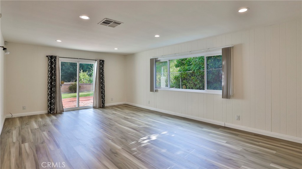304 Navajo Springs Road Diamond Bar, CA 91765 - Photo 8 of 39 a view of an empty room with wooden floor and a window