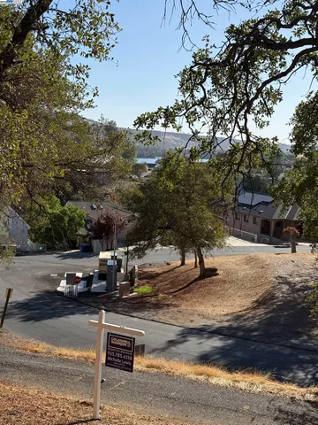a view of a yard with wooden fence