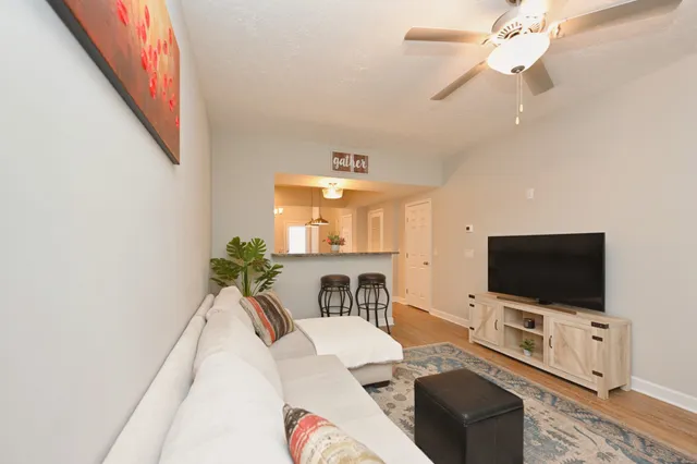 a living room with furniture and a flat screen tv