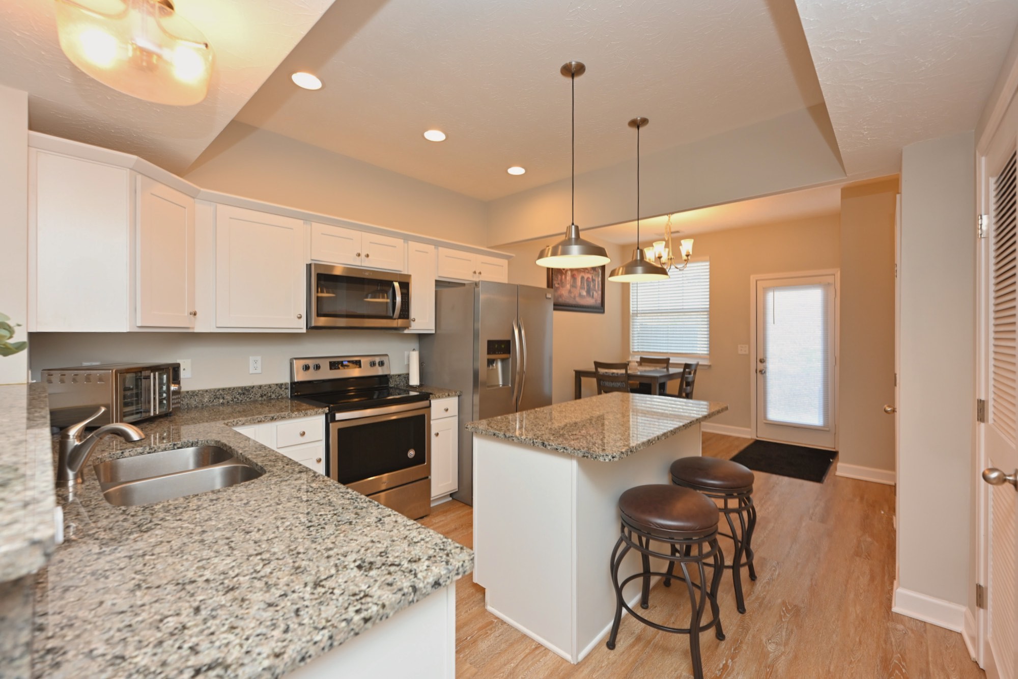 1382 Rural Hill Road, Unit 337 Antioch, TN 37013 - Photo 19 of 45 a kitchen with kitchen island granite countertop a sink appliances cabinets and furniture