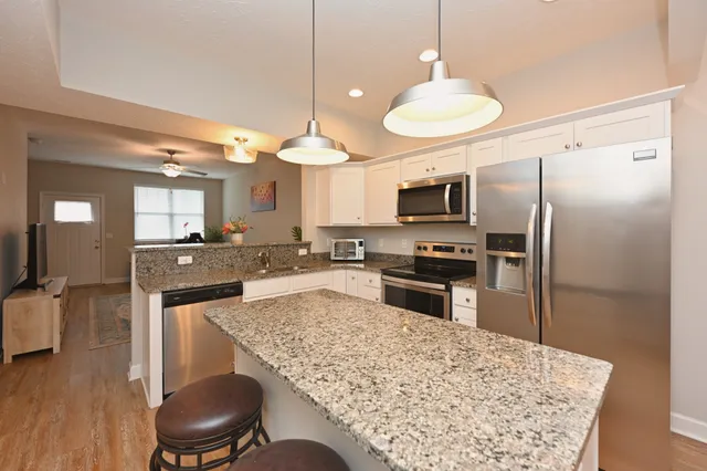 a kitchen with a refrigerator a stove top oven a sink and dishwasher