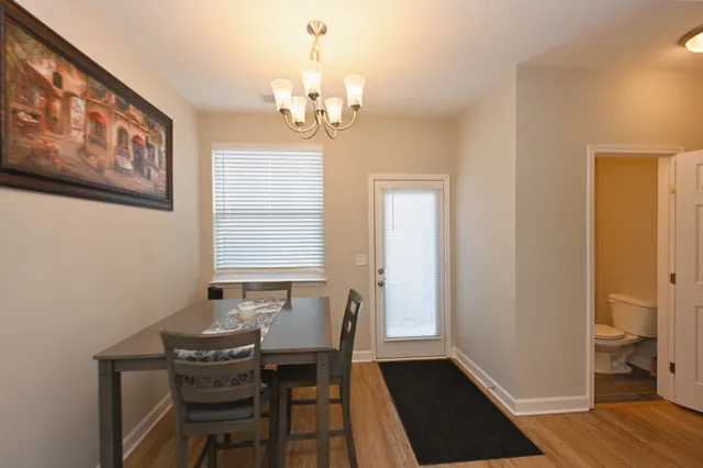 a view of a dining room with furniture and wooden floor