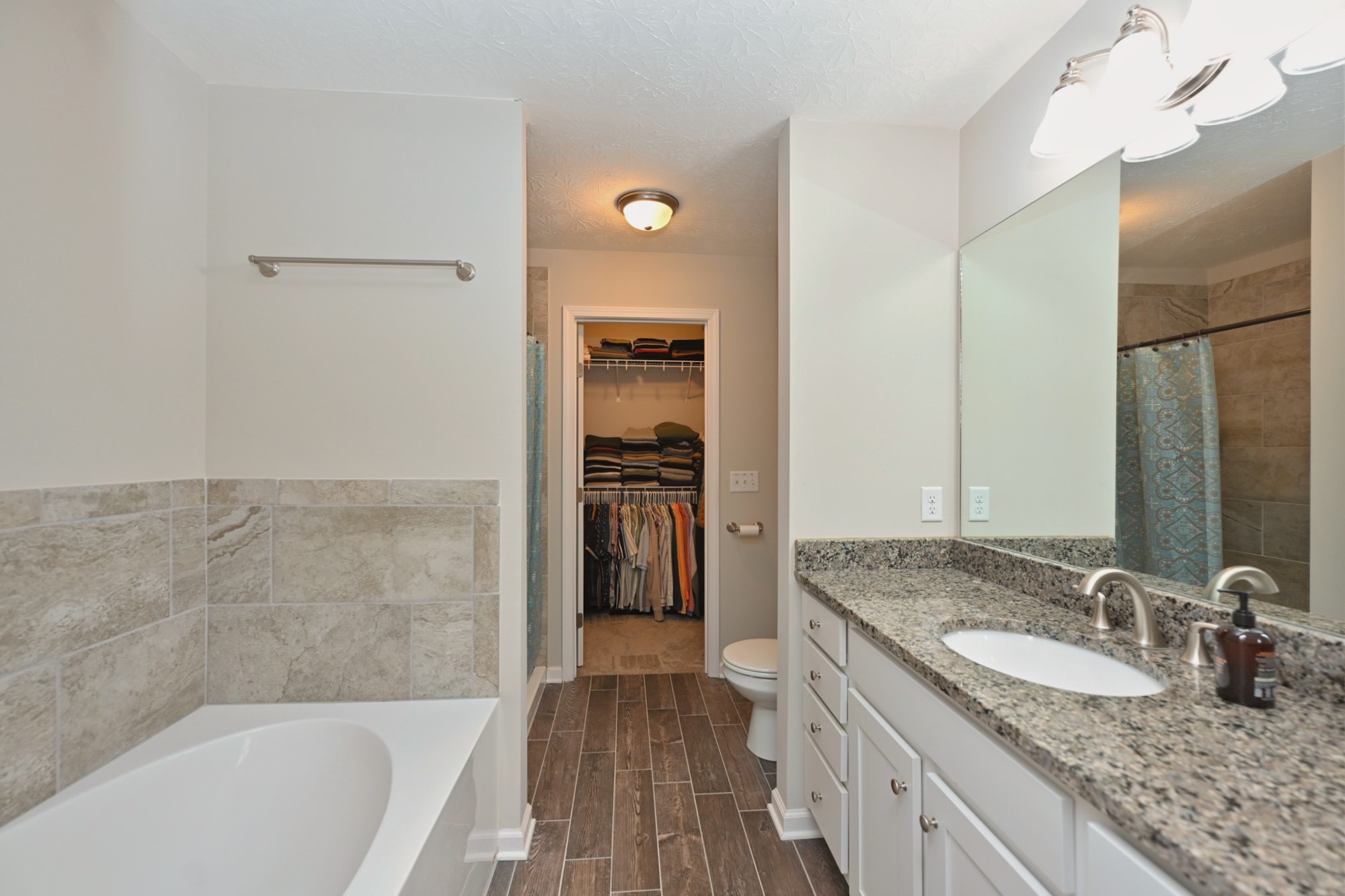 1382 Rural Hill Road, Unit 337 Antioch, TN 37013 - Photo 35 of 45 a bathroom with a granite countertop sink tub and a mirror
