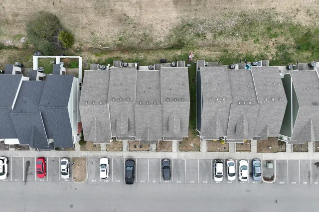 an aerial view of a house with large trees